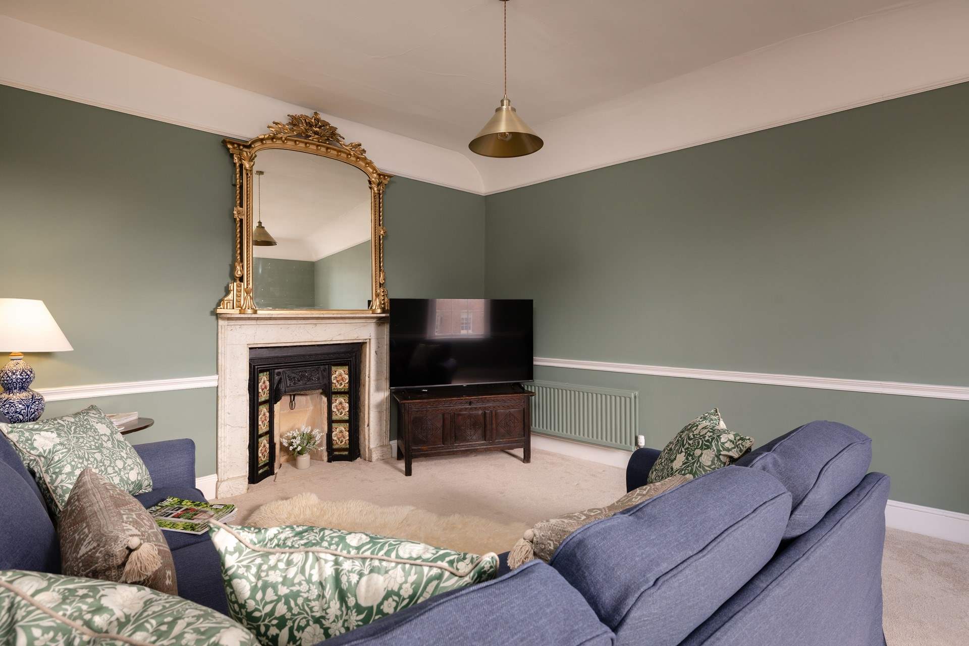Soft colours and a cosy sofa add up to a relaxed sitting-room.