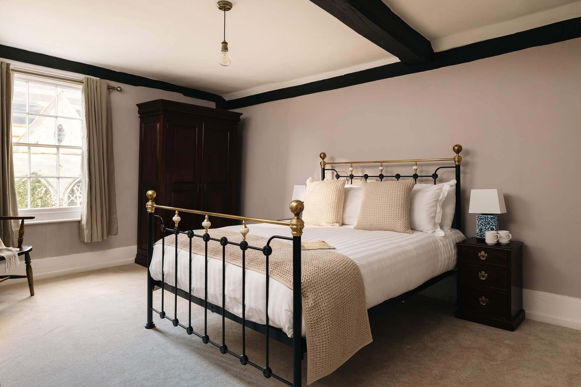 Antique furniture blends so well in this stylish bedroom.