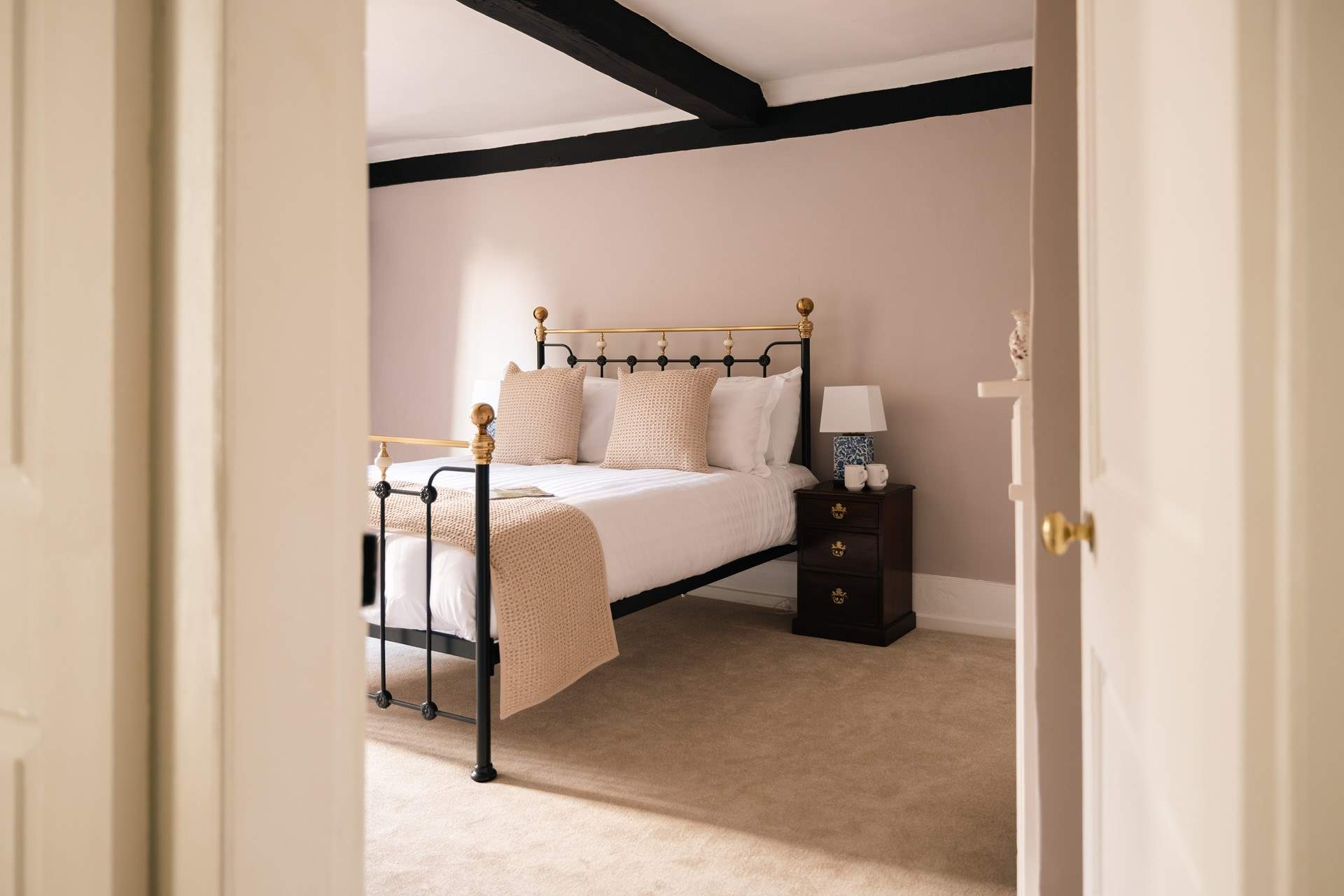 Original beams gracing the spacious bedroom.