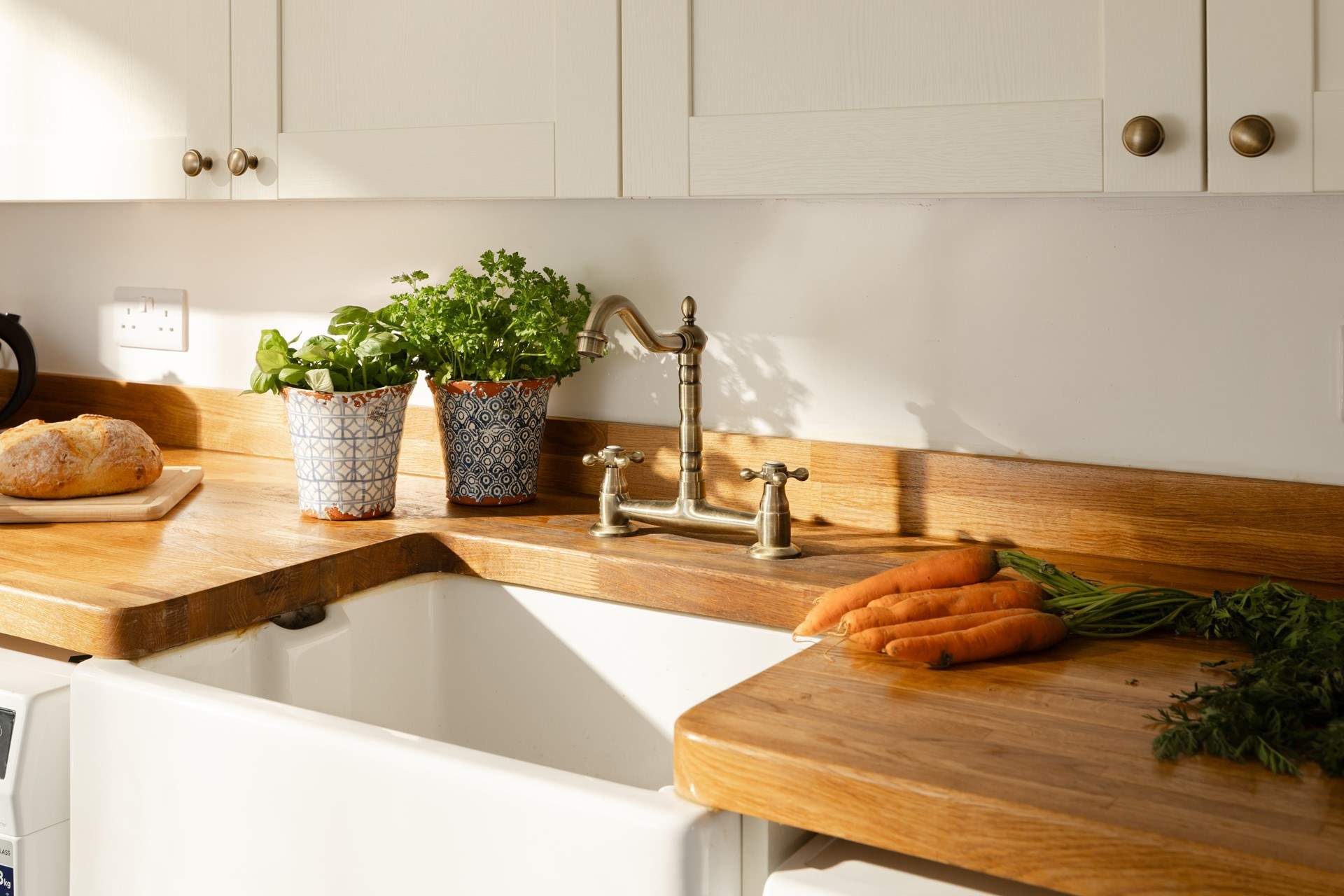 The antique-style taps and butler's sink match the style of this beautiful house.