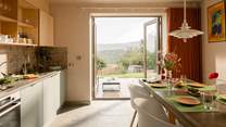 The double doors from the kitchen/diner open to the views beyond.