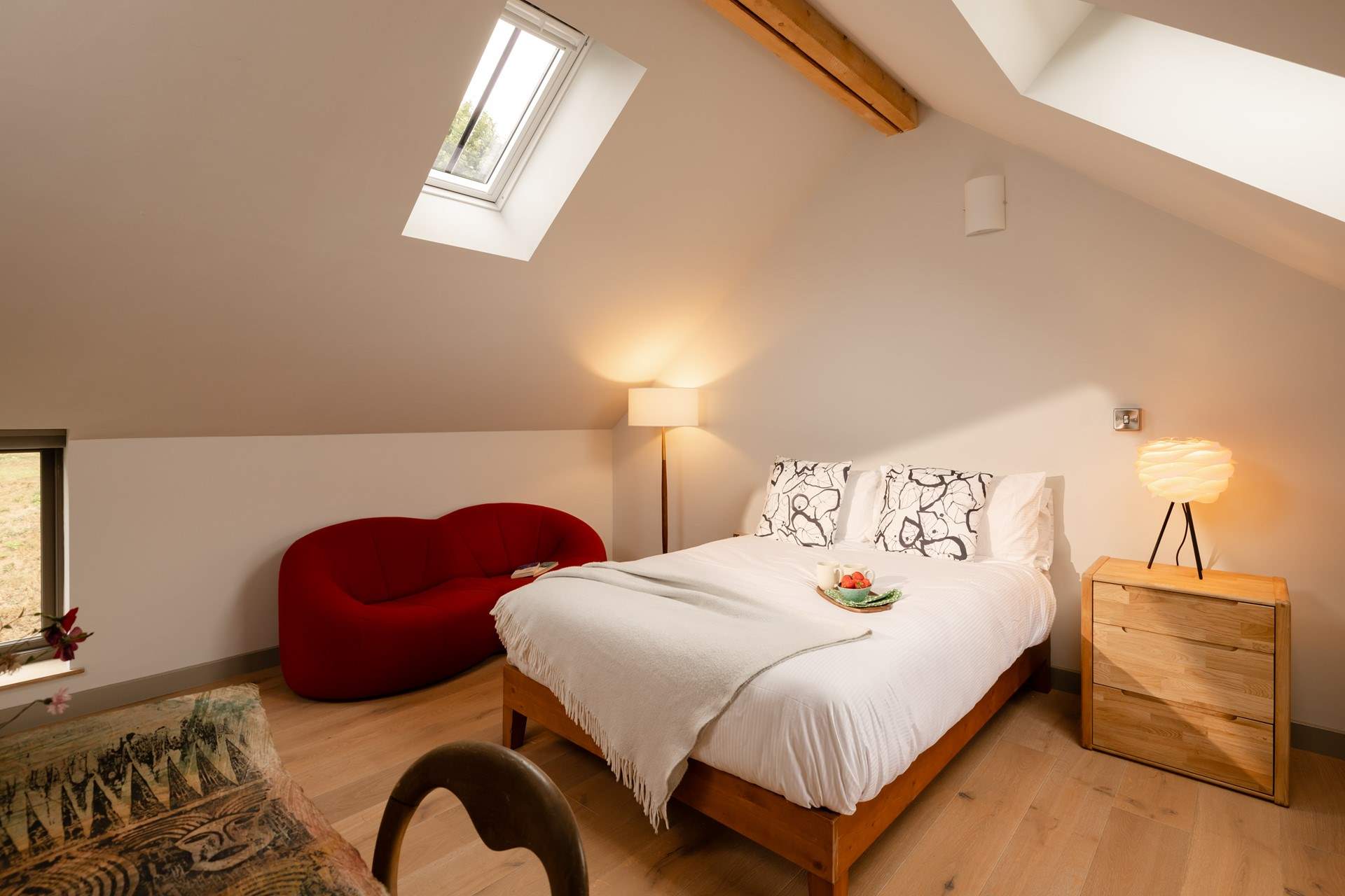 The light floods into this bedroom through the many windows.