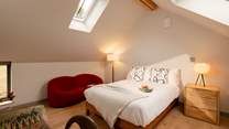 The light floods into this bedroom through the many windows.