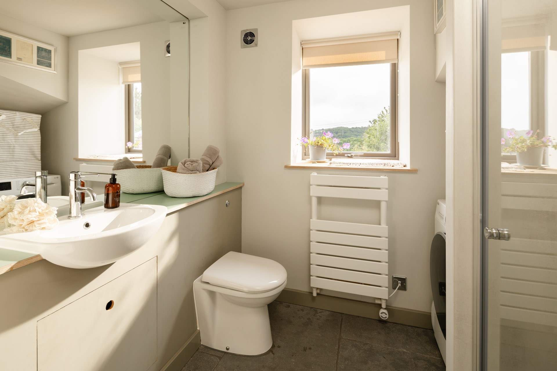 The ground floor shower-room also houses the washing machine.