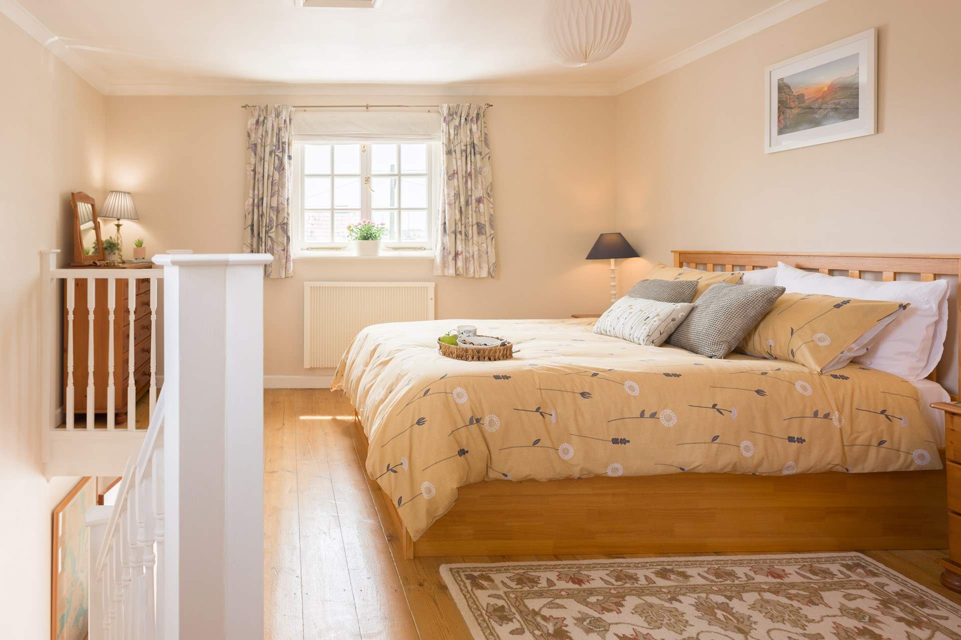 The pretty bedroom with calming tones and a king-size bed.
