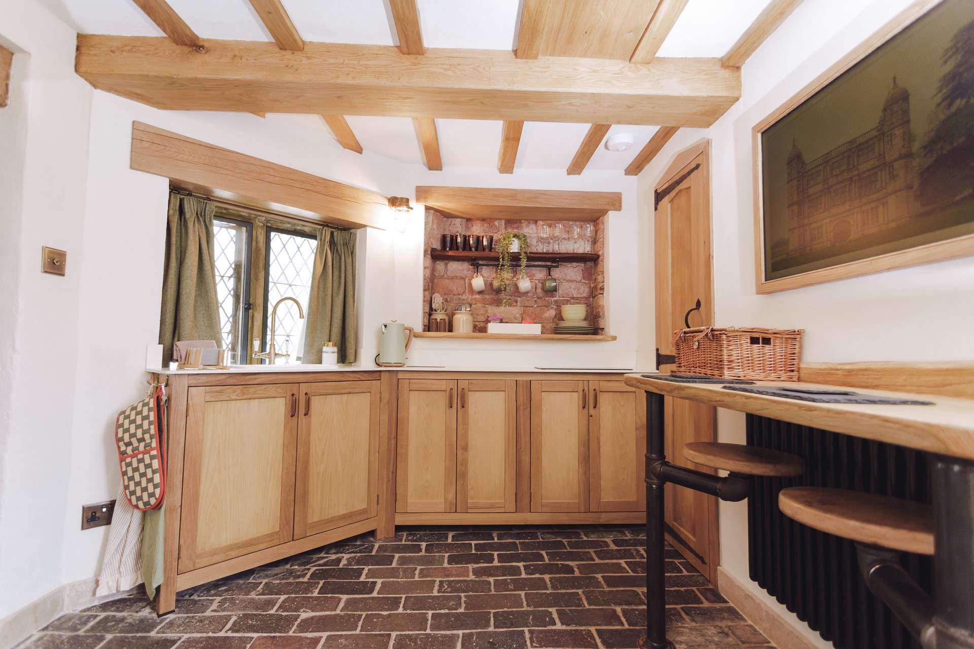 The toilet sits to the right of the kitchen under the stairs. 