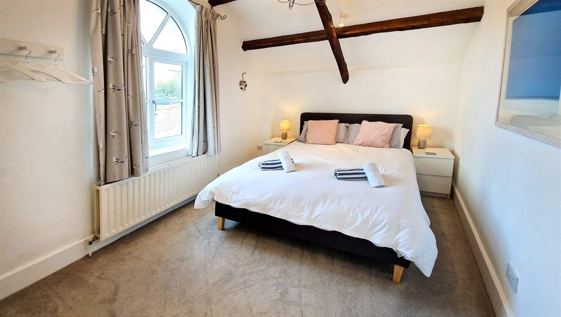 Bedroom 1 has characterful beams and a comfy king-size bed.