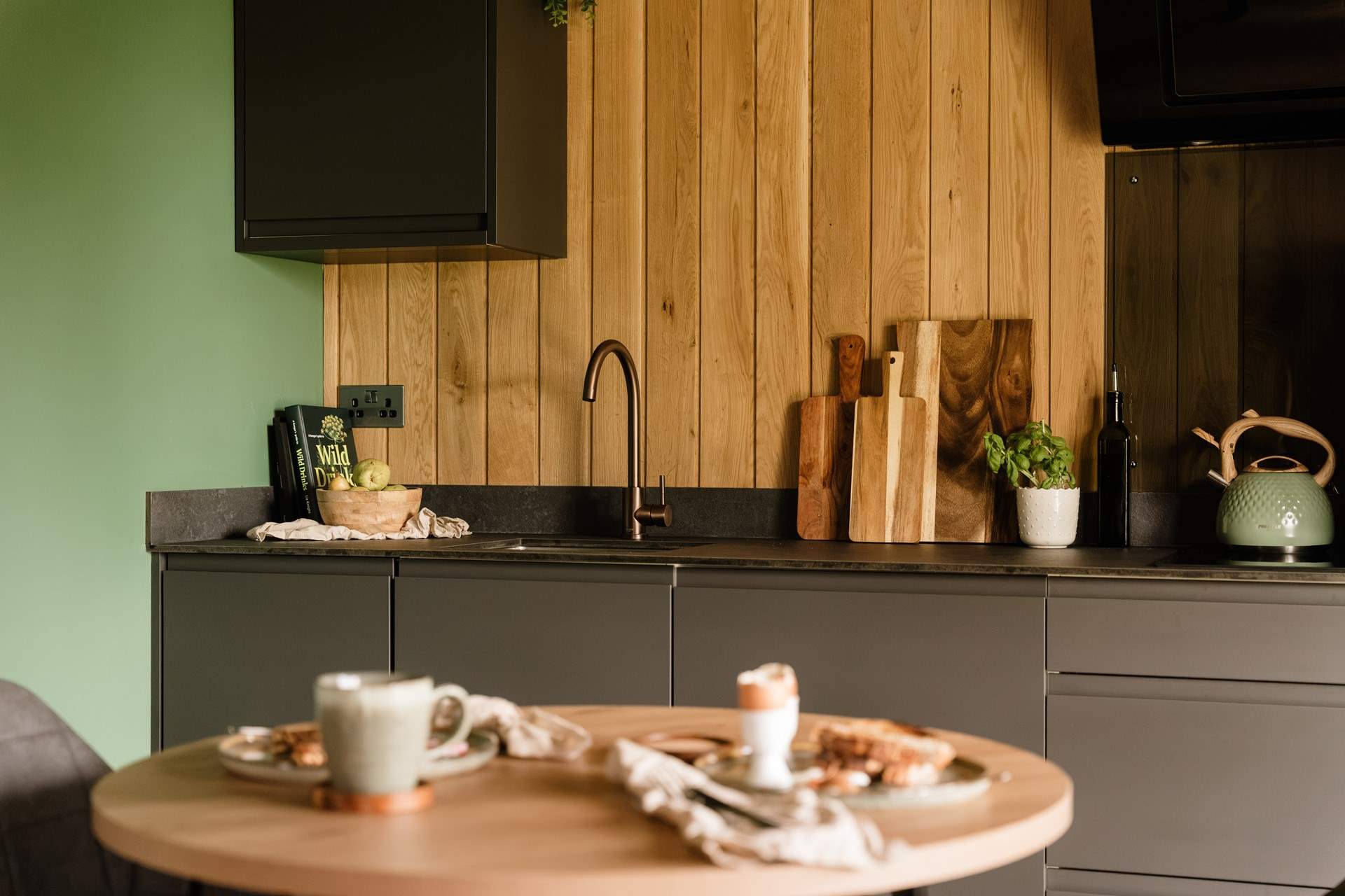 The sleek kitchen is equipped with everything you could need. 