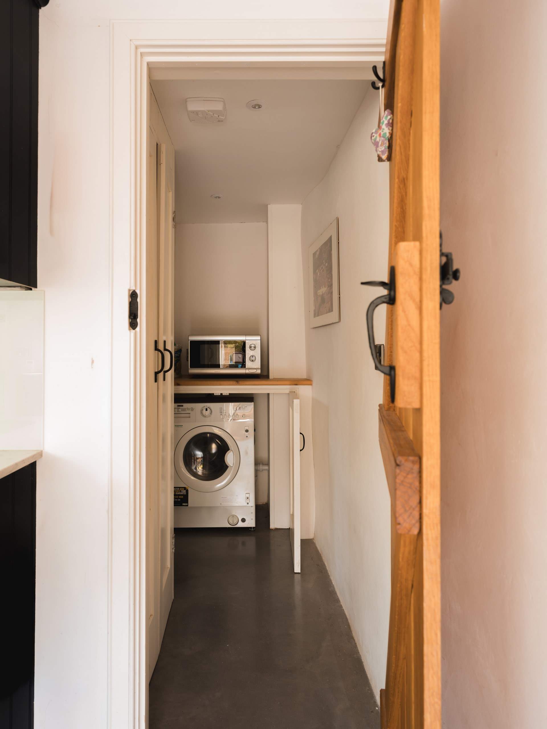 To further enhance the kitchen you will find a separate utility-room with washing machine/drier.