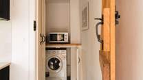To further enhance the kitchen you will find a separate utility-room with washing machine/drier.