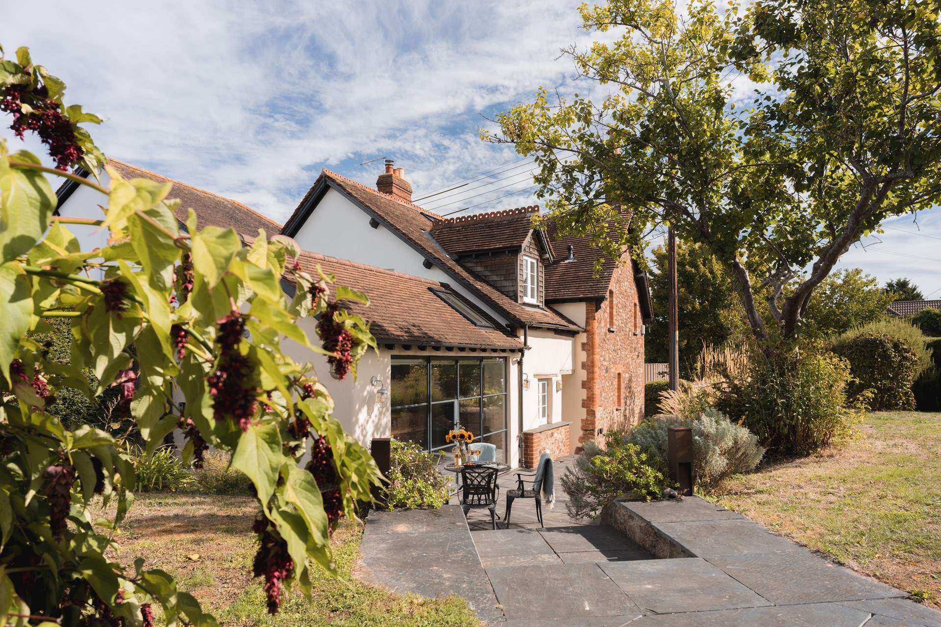 Elm Cottage is just as pretty on the outside with sprawling cottage gardens.