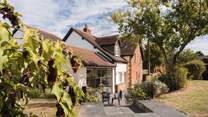 Elm Cottage is just as pretty on the outside with sprawling cottage gardens.
