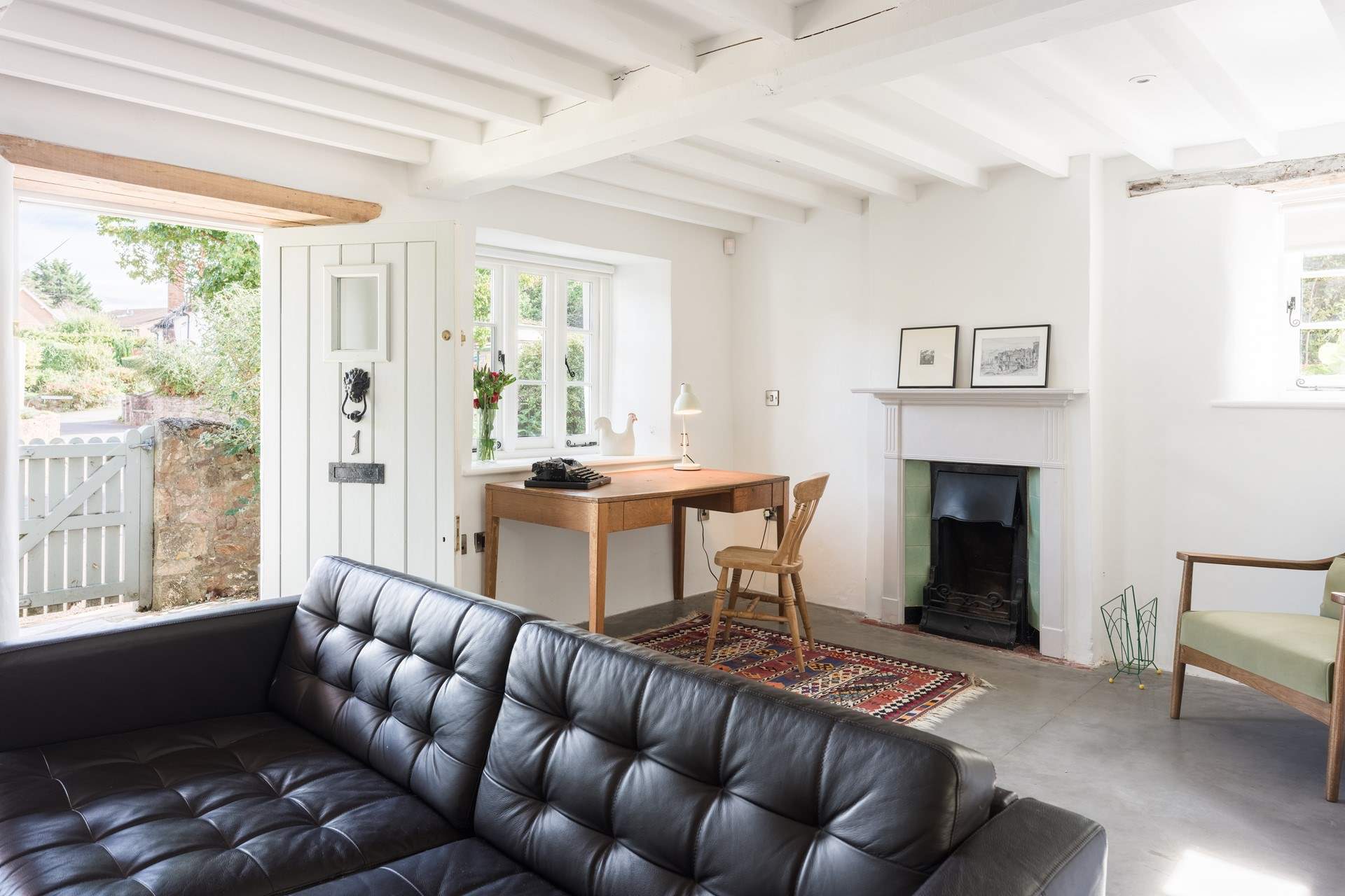 Having a sunny dual-aspect the sitting-room also has a door out to the gardens and a very handy little work space. 