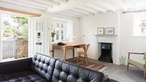 Having a sunny dual-aspect the sitting-room also has a door out to the gardens and a very handy little work space. 