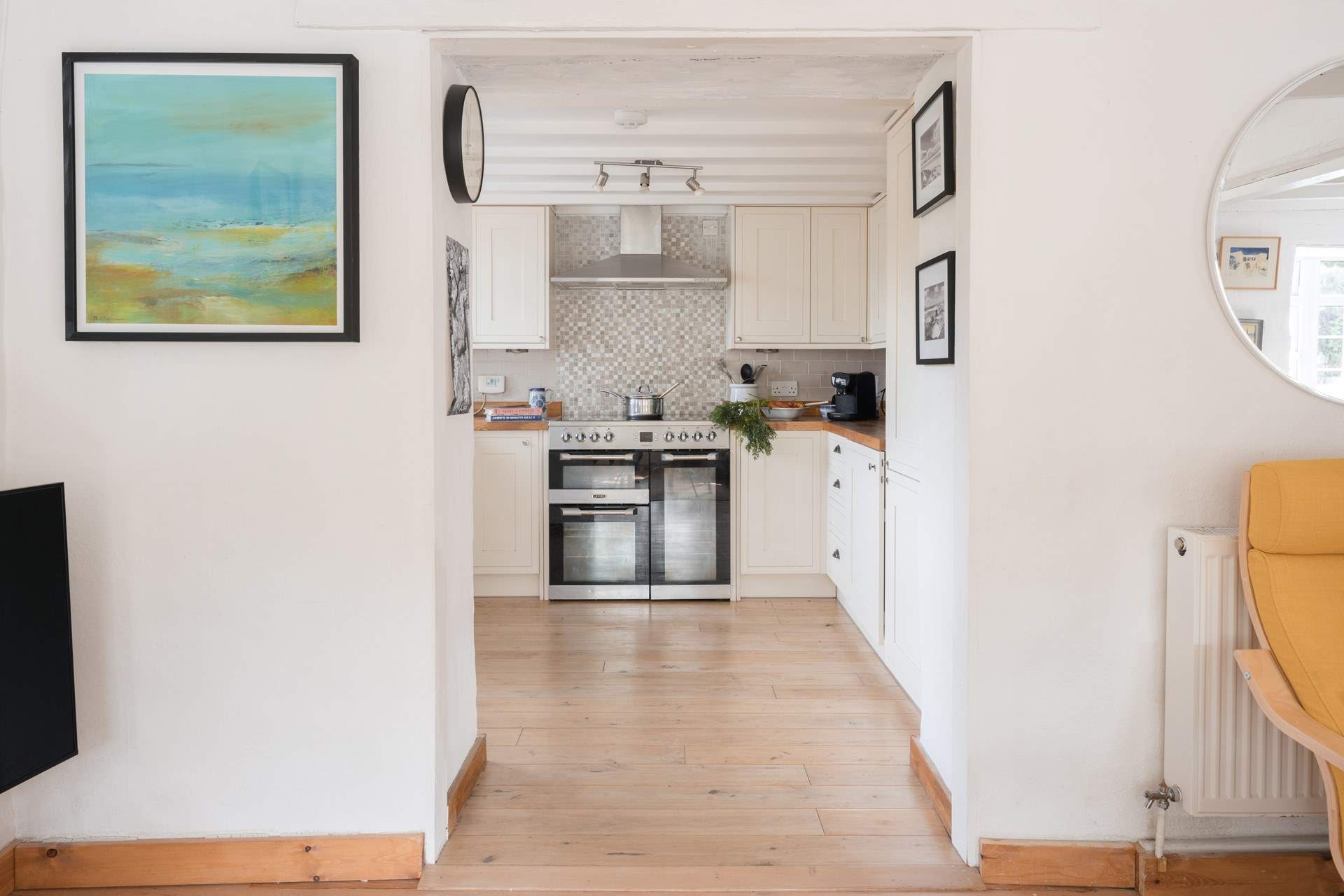 From the sitting-area you can access the kitchen and the back door.