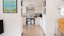 From the sitting-area you can access the kitchen and the back door.
