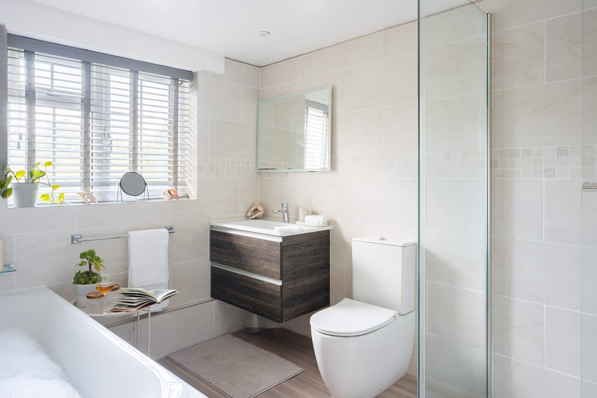 The family bathroom is spacious and has a shower cubicle and a bath.