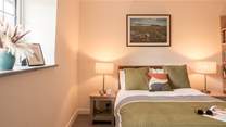 The bedroom looks out to the front across the trees and fields.