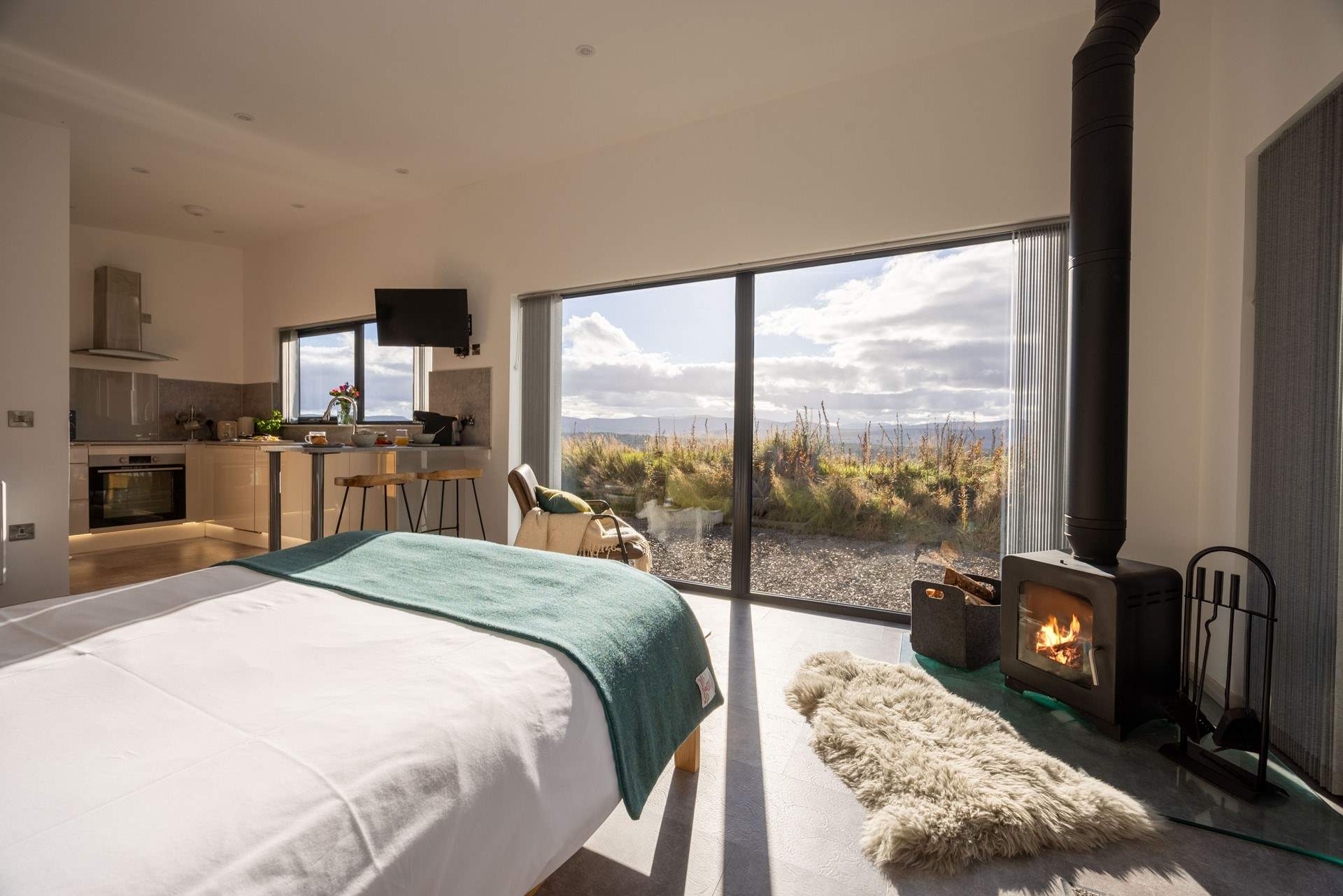Enjoy far-reaching views of the mountains from the luxurious king-sized bed.