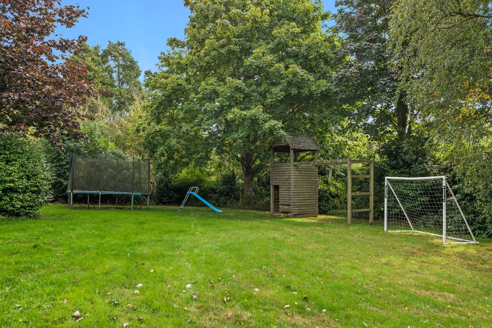 The lawn space extends to a play-area for the younger members of the party.