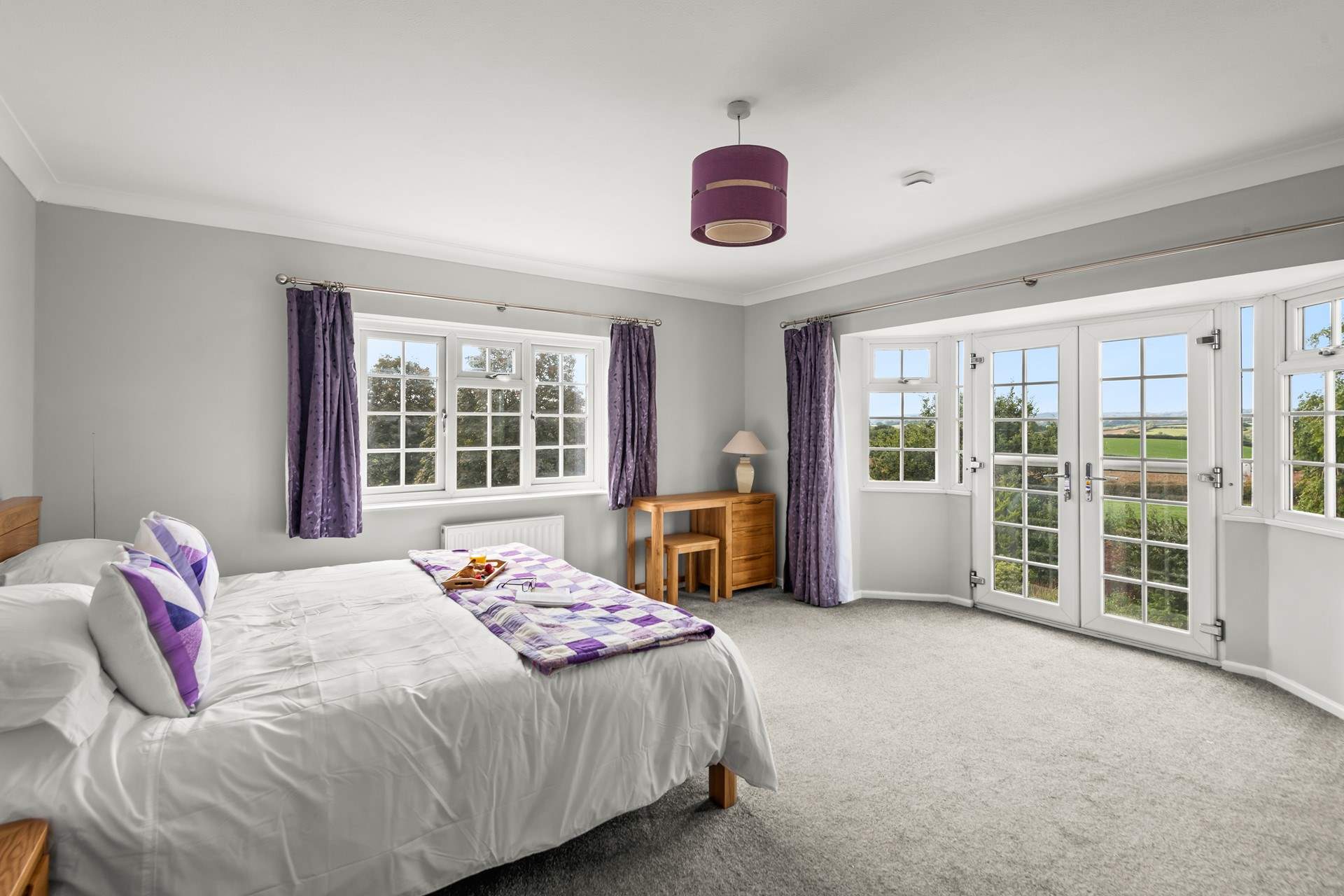 This beautiful bedroom has wonderful panoramic countryside views.