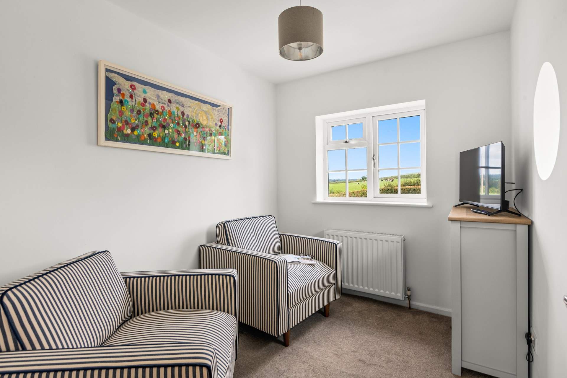 Heading upstairs, you have this cute little snug equipped with a television; perfect for those seeking some peace and quiet.