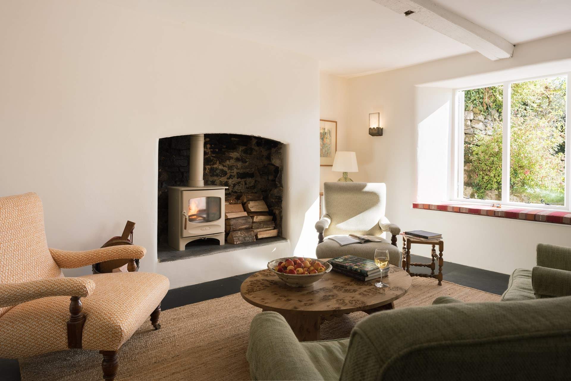 The sitting-room, with wood-burner, is both beautiful and relaxed. There's a TV tucked away in a bespoke cabinet should you wish to enjoy a film together.