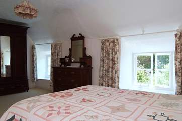 Two windows allow sunlight to flood in to this spacious bedroom (Bedroom1).