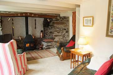 A welcoming wood-burner nestles in the huge inglenook fireplace.