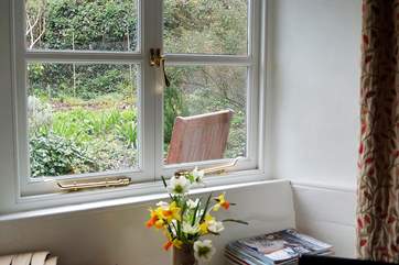 The sitting-room overlooks the pretty cottage garden at the front.