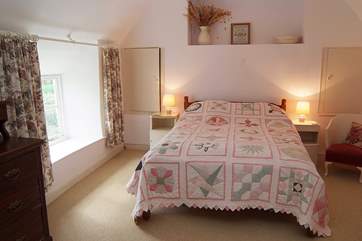 Bedroom 1 is a spacious double room overlooking the pretty cottage garden at the front.