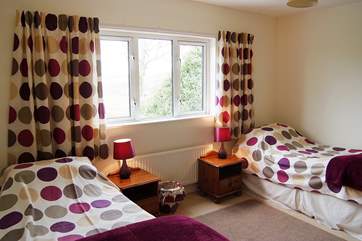 The twin bedroom with views across the rear garden and countryside beyond (Bedroom 2).