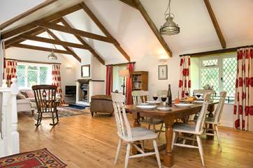 The spacious L shaped living room with beautiful wooden floors.