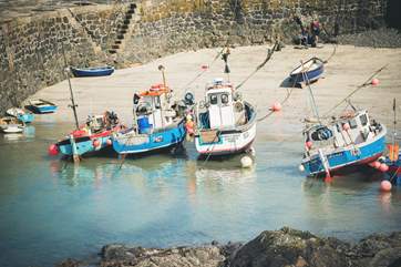 Watch the boats come in and out of this little fishing harbour.