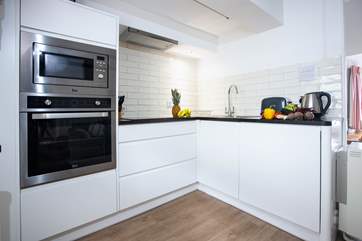 The attractive kitchen is very well-equipped with a built-in microwave, oven and hob.
