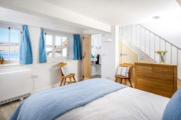 On the lower floor, the gorgeous bedroom has a view across the bay.