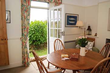A door in the dining-room leads to the stairs, and another door opens out to the garden.