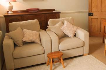 The sitting-room is furnished with a sofa and these two comfy chairs.