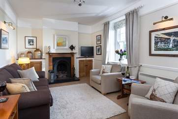 The Victorian cast-iron fireplace adds character to the cosy sitting-room as well as additional warmth on those cooler evenings.