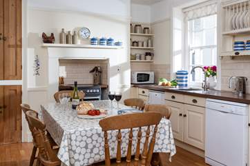 The kitchen, complete with farmhouse kitchen table, is extremely well-equipped.