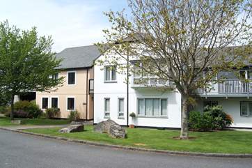 La Miette is the first-floor apartment in the white building, seen from the parking-area at the rear.