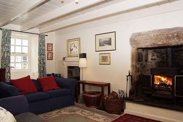 The sitting-room has a cosy wood-burner.