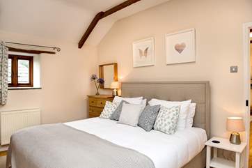 The master bedroom (Bedroom 4) on the first floor has a super comfy king-size bed.