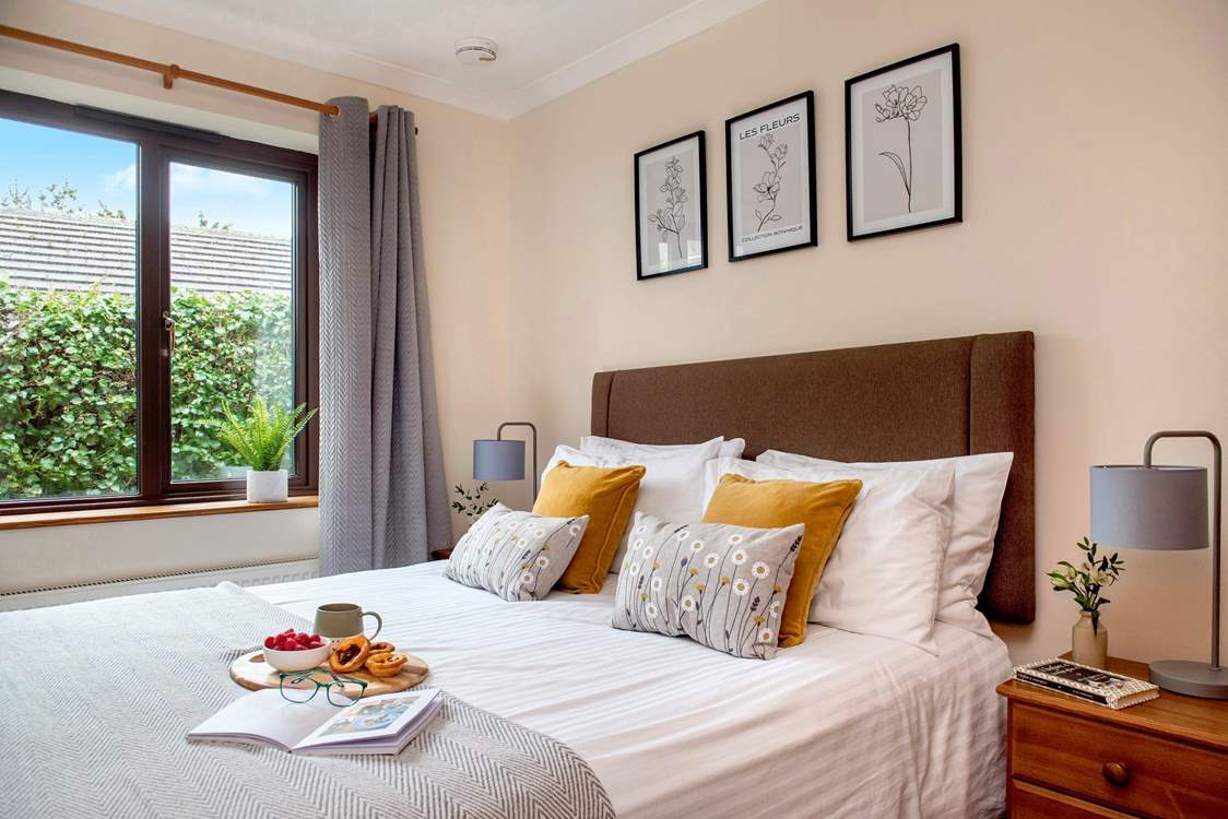 Bedroom two has a lovely floral theme, with splashes of ochre.