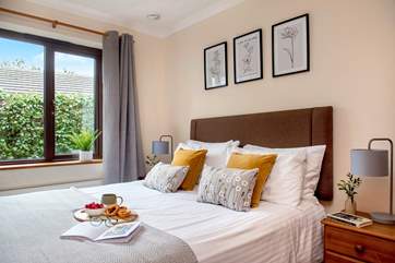 Bedroom two has a lovely floral theme, with splashes of ochre.