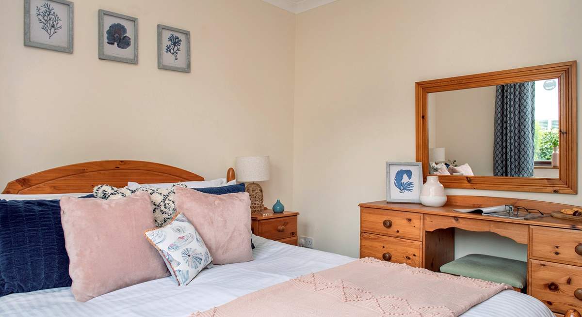 Lovely cushions and throw adorn the king-size bed. 