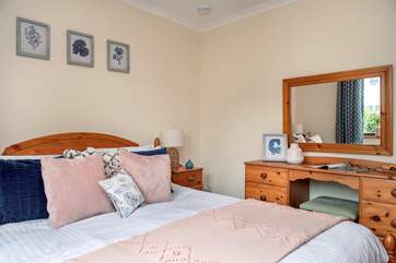 Lovely cushions and throw adorn the king-size bed.