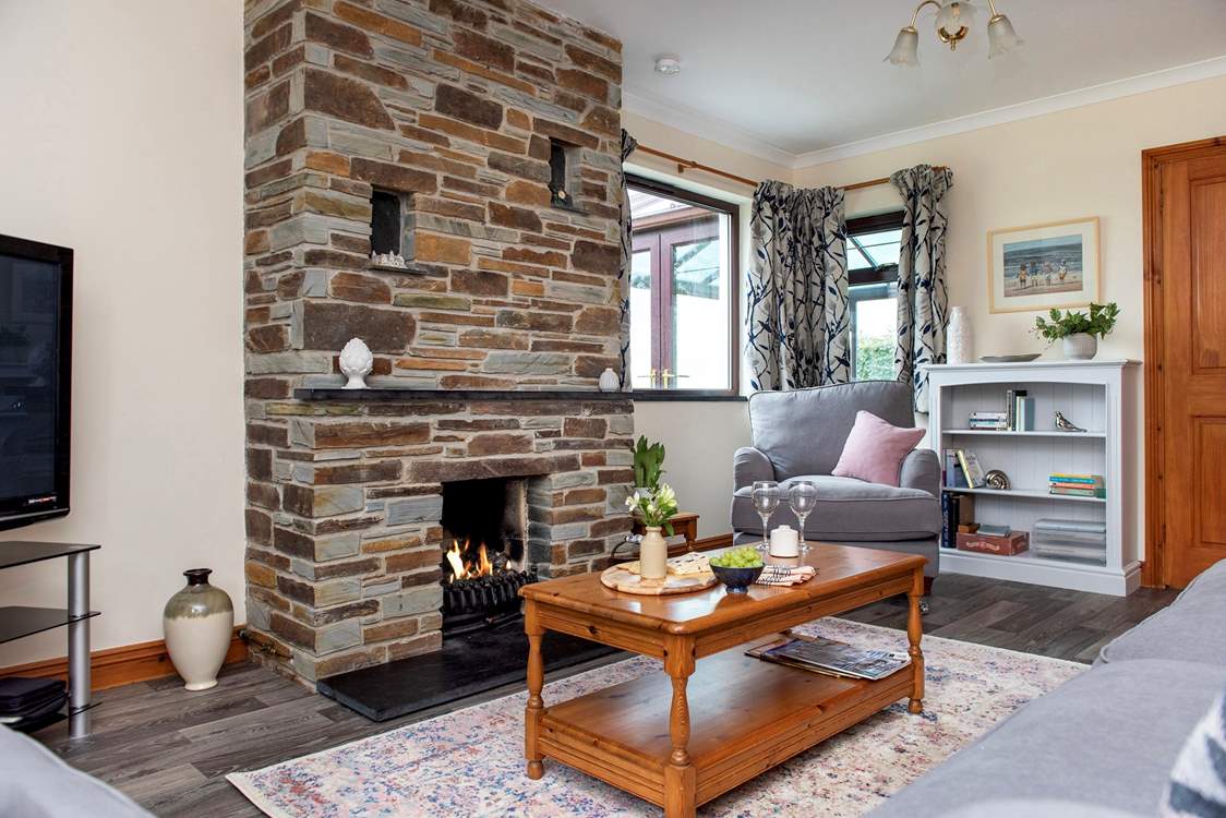 Snuggle up with a good holiday read. Please note, the 'living flame' fire is no longer in use.