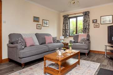 The comfy sitting-room has some lovely artwork of coastal scenes and places in Cornwall.