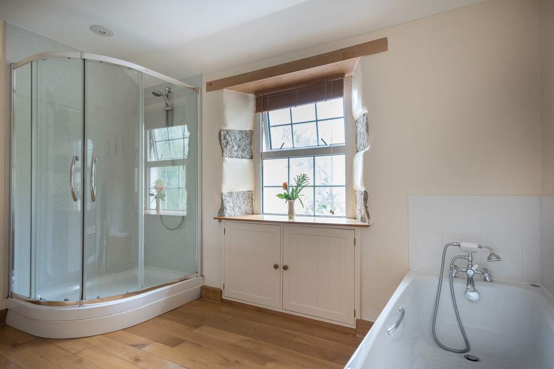 The spacious family bathroom with a large shower cubicle and a good sized bath to relax in after a day out exploring.